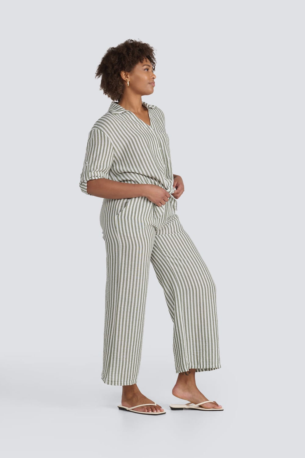 Olive green and white striped tie-front shirt and matching cropped wide-leg pants.