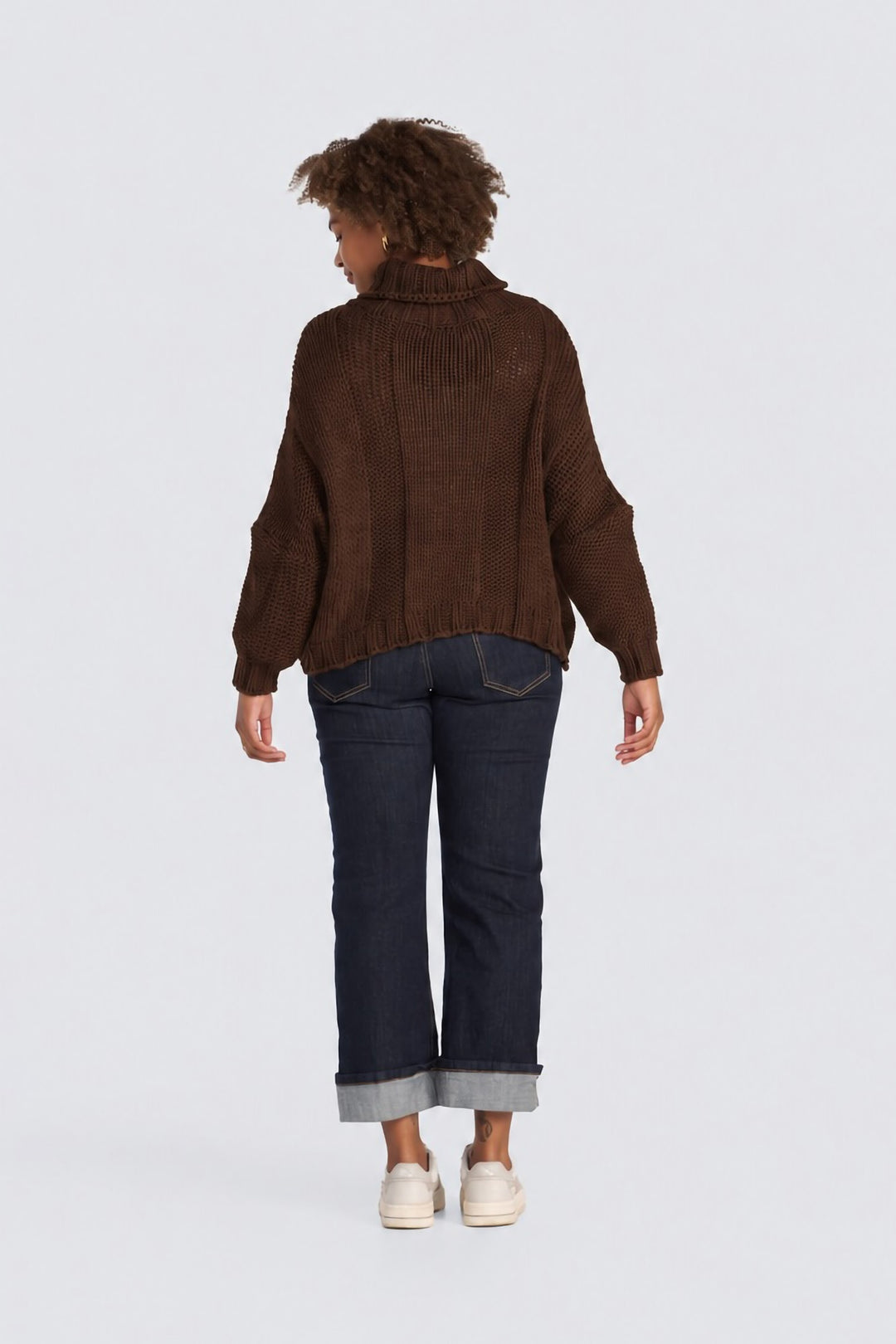 Dark brown chunky knit turtleneck sweater shown from the back.