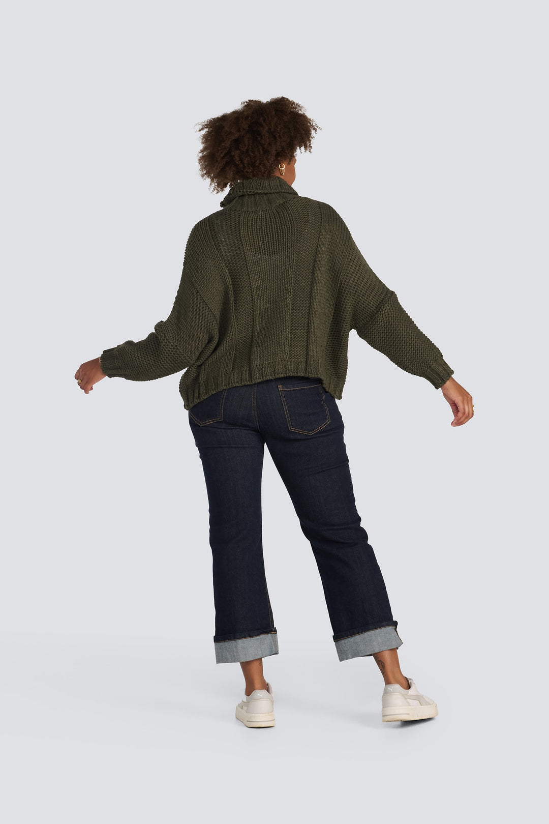 Olive green chunky knit turtleneck sweater with long sleeves and ribbed texture.