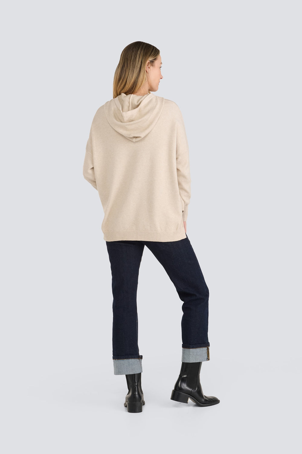 Beige knit hooded sweater with long sleeves and a ribbed hem, back view.