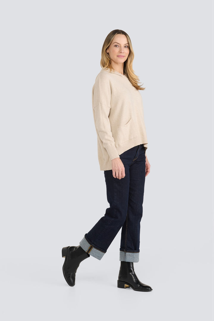 Beige knit hooded sweater with a front patch pocket and ribbed hem.