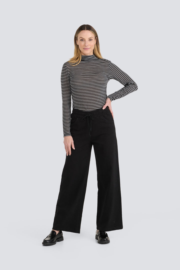 Grey and black striped long-sleeve turtleneck top paired with black wide-leg drawstring pants.