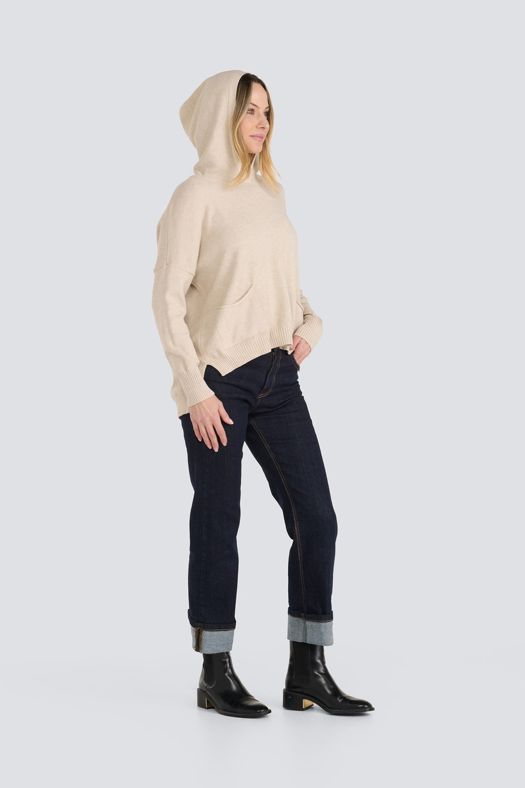 Beige hooded knit pullover sweater with long sleeves, ribbed hem, and front pockets.