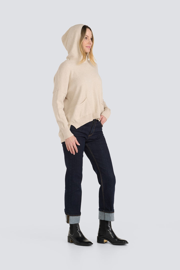 Beige hooded knit pullover sweater with long sleeves, ribbed hem, and front pockets.