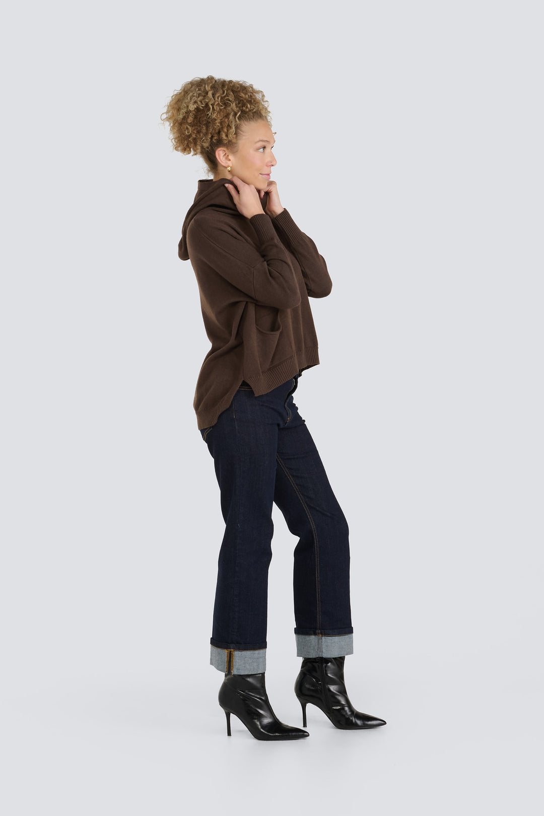 Dark brown knit hooded sweater featuring long sleeves and a high-low hem.