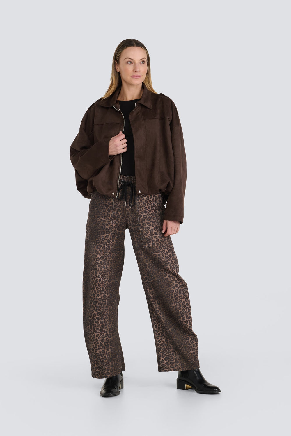 Dark brown suede zip jacket paired with wide-leg brown leopard print pants.