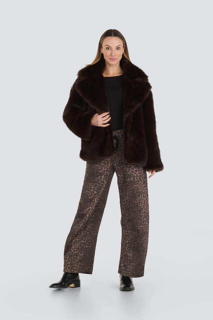 Dark brown faux fur jacket with wide lapels and leopard print wide-leg pants.
