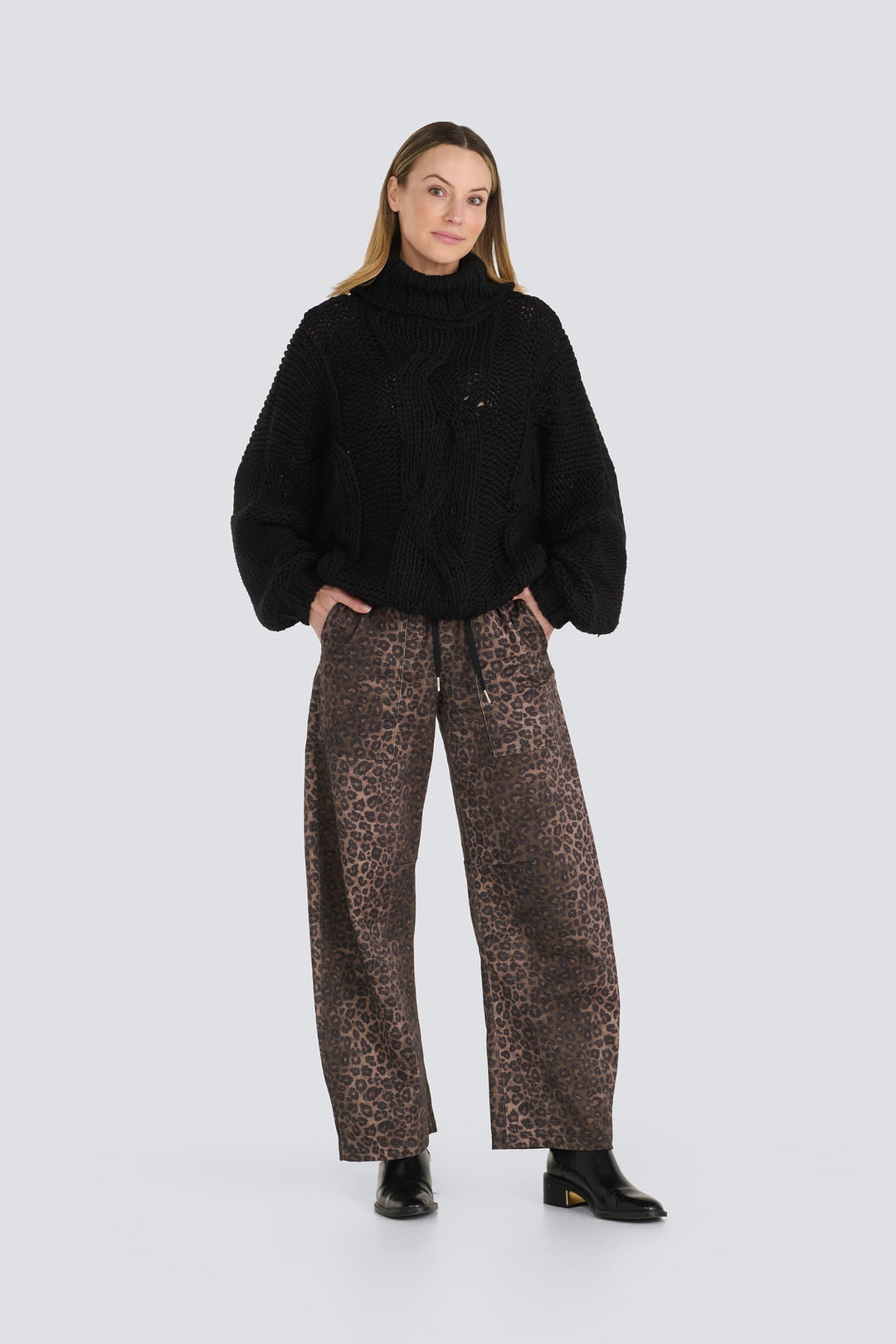 Brown leopard print wide-leg denim pants with a drawstring waist and patch pockets.
