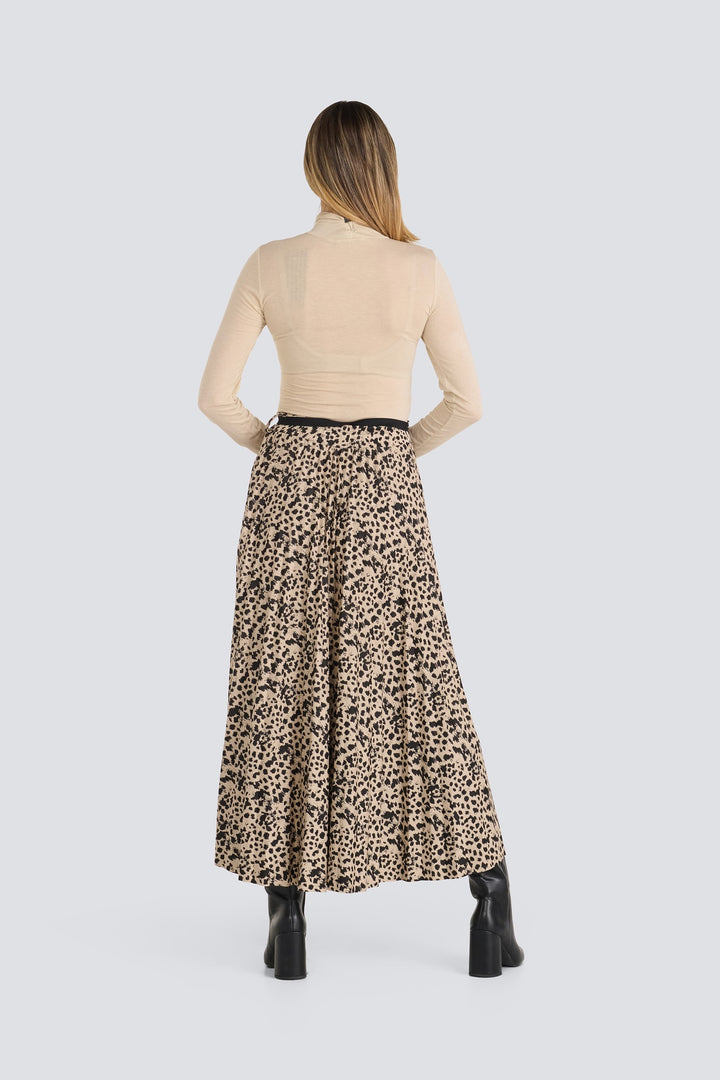 Beige animal print maxi skirt paired with a beige long-sleeved turtleneck top.