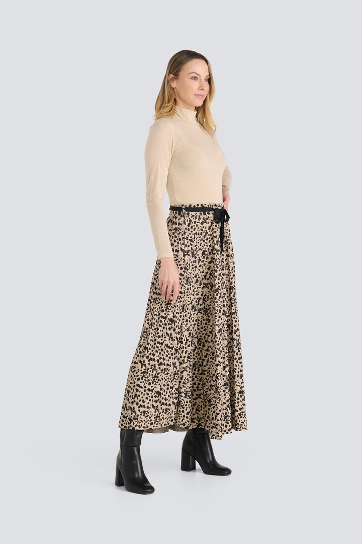 Beige long-sleeve turtleneck tucked into a black and beige leopard print maxi skirt.
