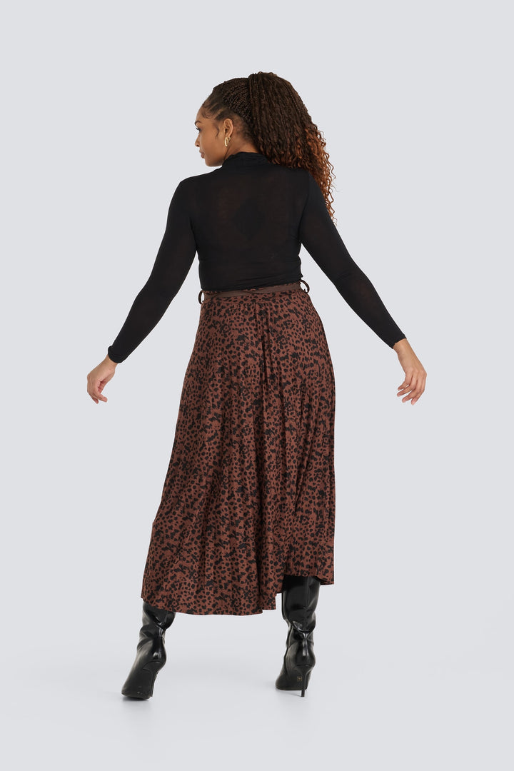 Brown leopard print pleated midi skirt paired with a black turtleneck top.