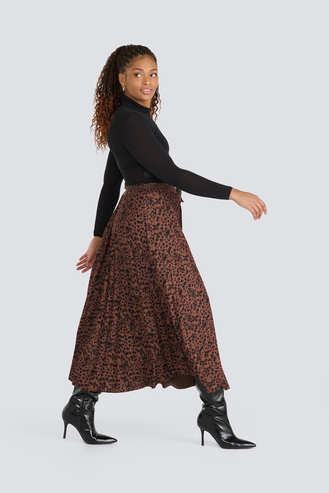 Brown leopard print pleated midi skirt styled with a black long-sleeve turtleneck.