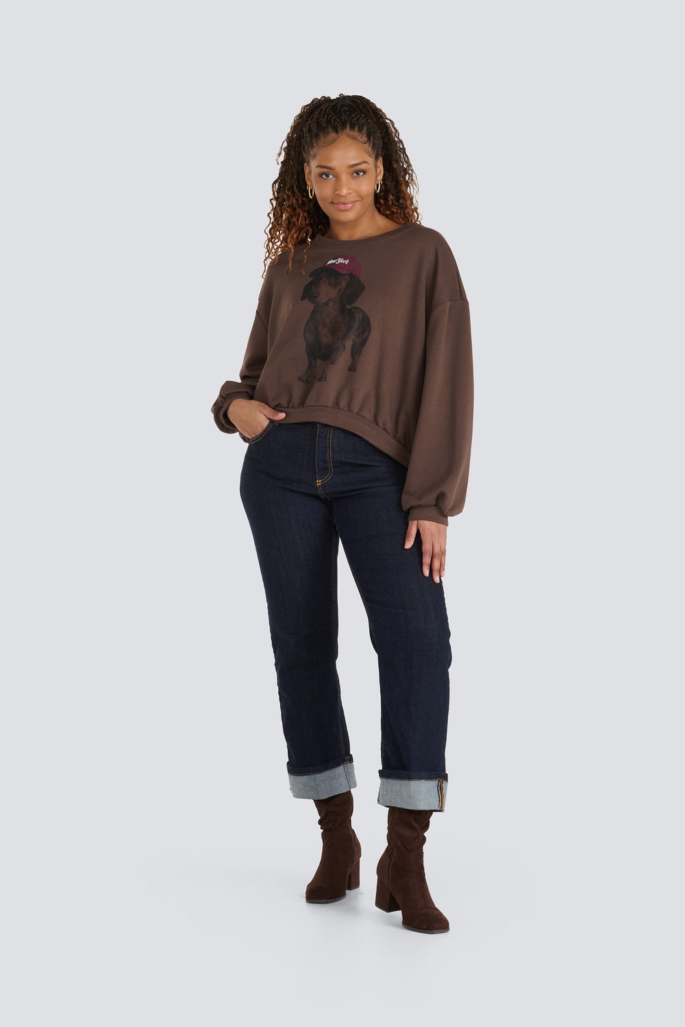 Brown sweatshirt with a graphic print of a dachshund wearing a burgundy hat.