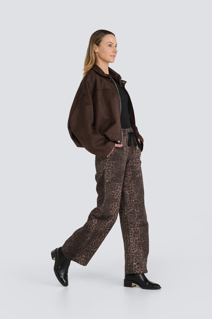 Brown oversized zip-front jacket styled with brown leopard-print wide-leg pants.
