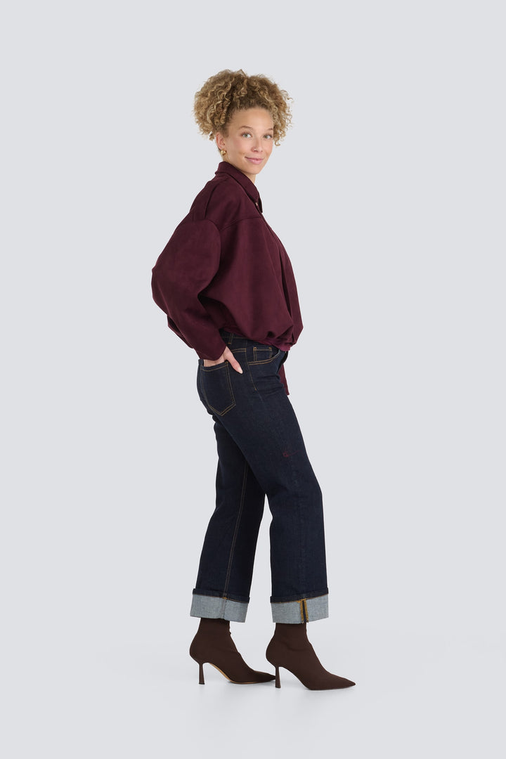 Dark wash straight-leg denim jeans featuring wide cuffed hems and contrast stitching.