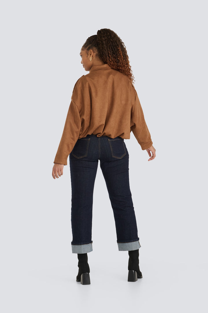 Brown suede jacket paired with cuffed dark wash jeans, shown from behind.