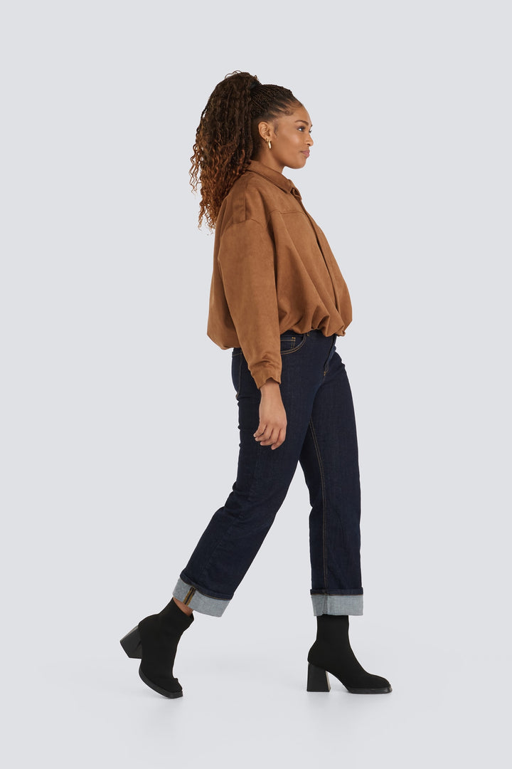 Brown suede shirt jacket paired with dark cuffed jeans and black ankle boots.