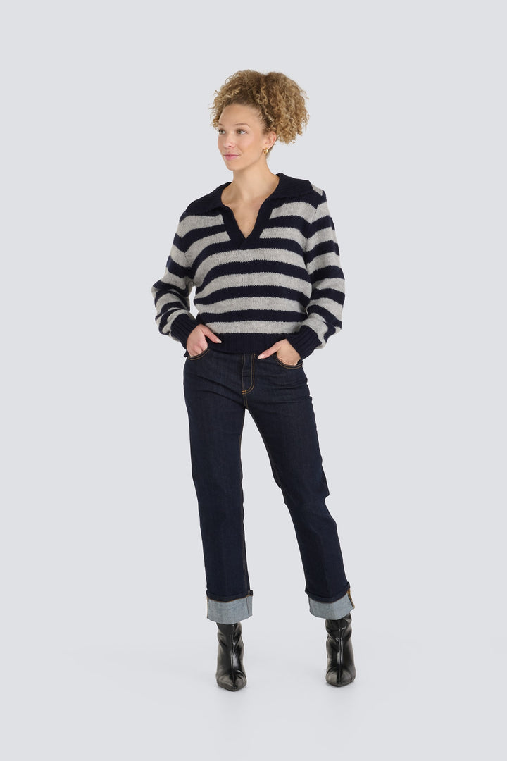 Grey and navy striped knit polo sweater with an open v-neck collar.