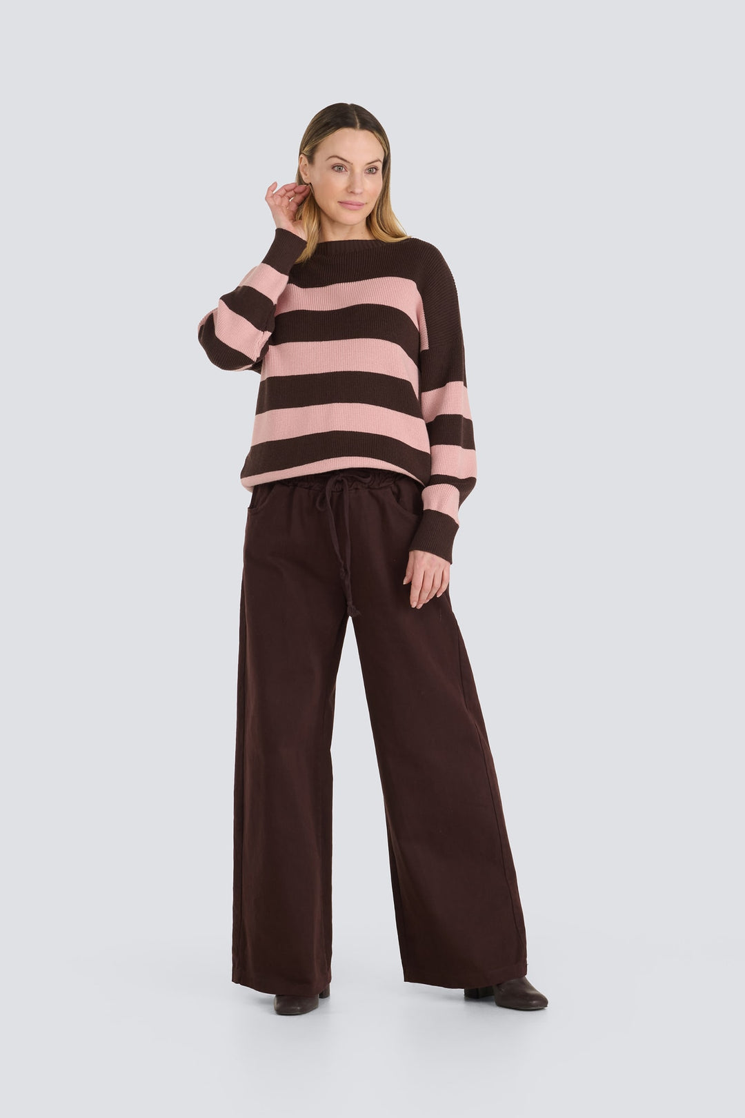 Dark brown and light pink striped round neck knit sweater.