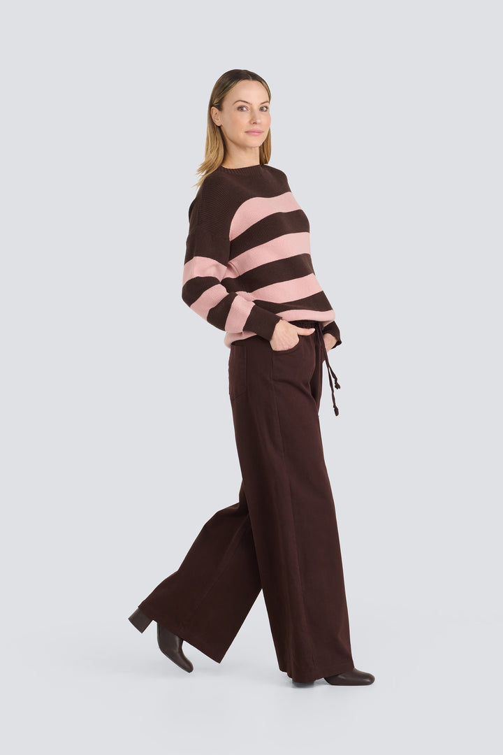 Brown and pink striped knit sweater with matching dark brown wide-leg pants.