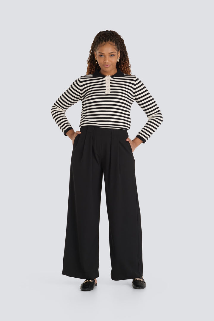 Black and cream striped sweater with a polo collar and button placket.
