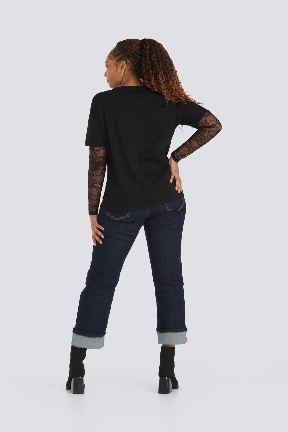 Black crew-neck t-shirt layered over sheer black floral lace long sleeves.