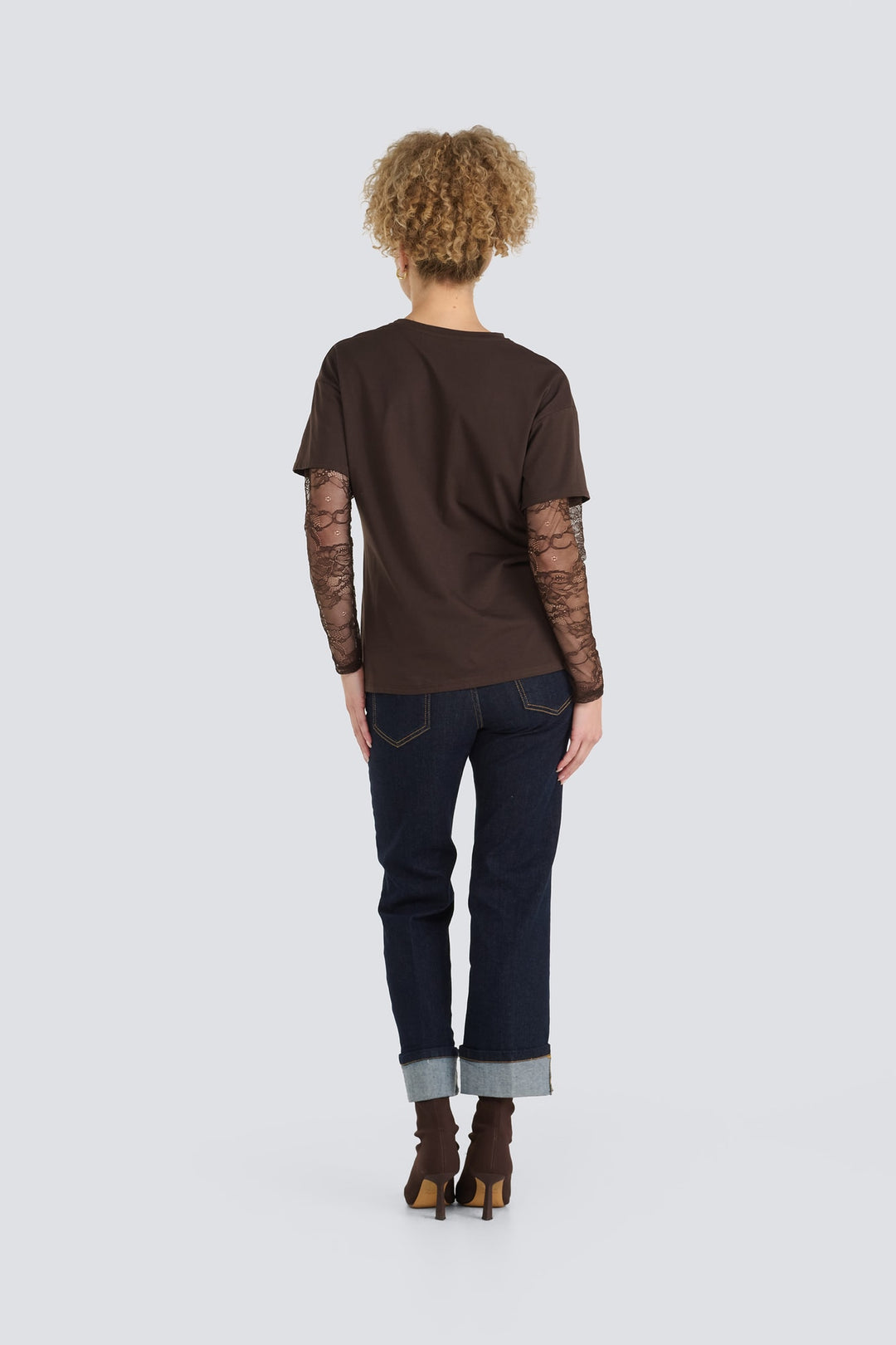 Dark brown t-shirt with long sheer lace sleeves shown from the back.